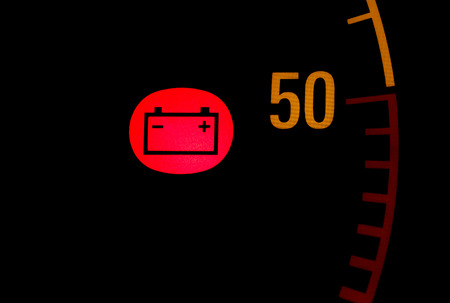 Battery low red light icon on car dashboardの写真素材