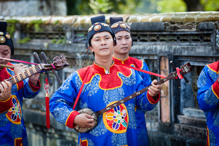 Hoi An, Vietnam - march 10 2017: vietnamese traditional music band is giving concert in Imperial Citadel. Musician is playing Dan Tam Three-string Lute.のeditorial素材