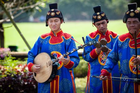 Hoi An, Vietnam - march 10 2017: vietnamese traditional music band is giving concert in Imperial Citadel. Musician in the foreground is playing Dan Nguyet Two-string Guitar.のeditorial素材