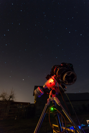Professional astrophotography telescope equipped with guider scope and astro camera is taking pictures of night skyの写真素材