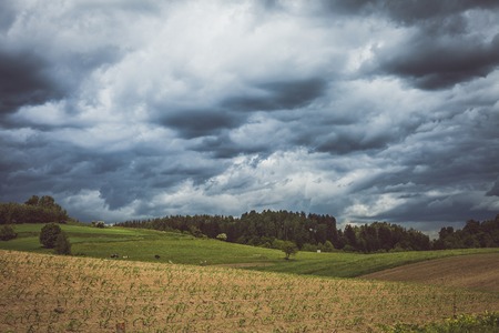 Stormy cloudscape over fields and pastureの写真素材