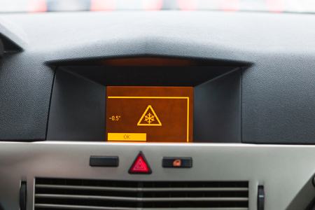 Slippery road warning on car display, car interior point of viewの写真素材