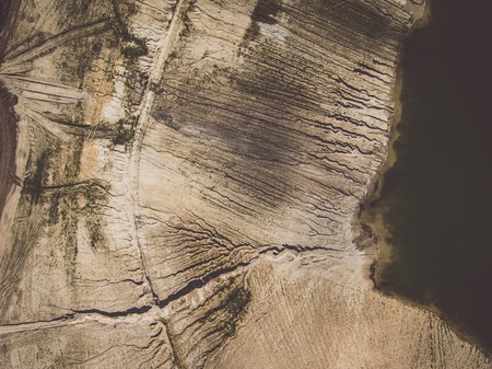 Abstract patterns of the earth and lake around the opencast mineの写真素材