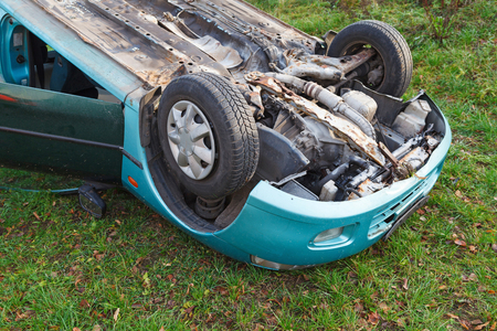Traffic accident, car after rollover lie on the roofの写真素材