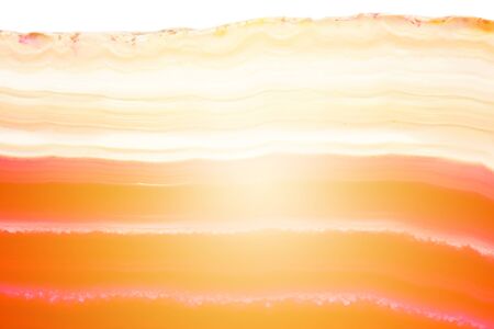 Abstract background, red and orange agate striped mineral cross section with sunbeam isolated on...