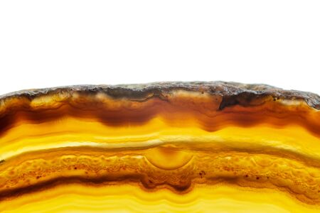 Abstract background, brown and orange striped agate slice mineral cross section isolated on white backgroundの写真素材