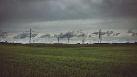 Moody sky over meadow and power lines