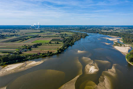 Distant power station under moody cloudy sky aerial view