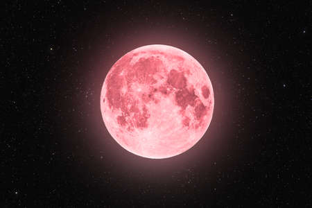 Pink full super moon glowing with pink halo surrounded by stars on black sky backgroundの写真素材