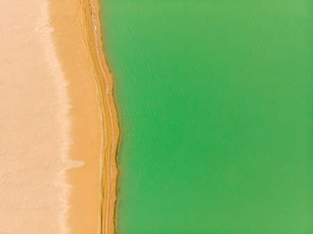 Emerald lake aerial view. Abstract fantasy green and yellow pattern background.