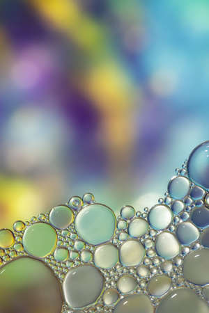 Fantasy colorful blurry background with ornament made of soft clear bubbles, abstract color splashes with copy space, focus on foregroundの写真素材