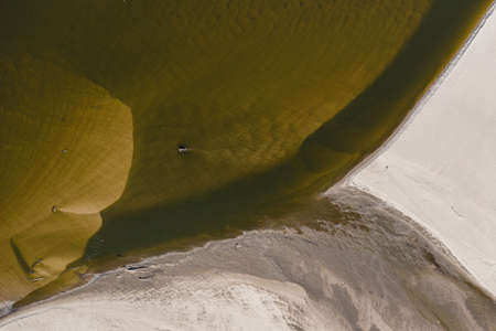 Low water level in Vistula river, effect of drought seen from the bird's eye view. Top down perspective landscape.の写真素材