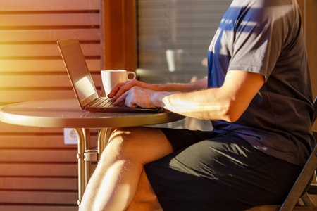 Working from home on the laptop. Wearing casual comfort outfit in home office.の写真素材