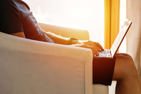 Working from home on the laptop. Wearing casual comfort outfit in home office.の写真素材