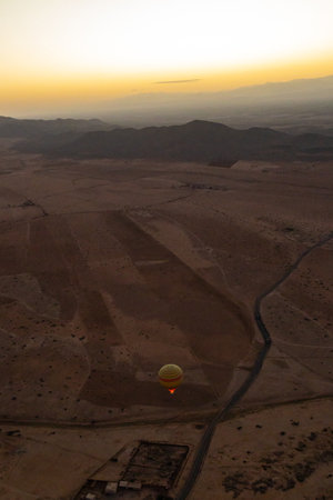 Hot air balloon flying over the desert at sunset, Egypt, Africaの写真素材