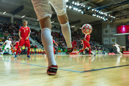 LUBIN, POLAND -  DECEMBER 2, 2019: Futsal friendly match Poland vs Serbia 4:1. Close up of ball in the corner and player's leg.のeditorial素材