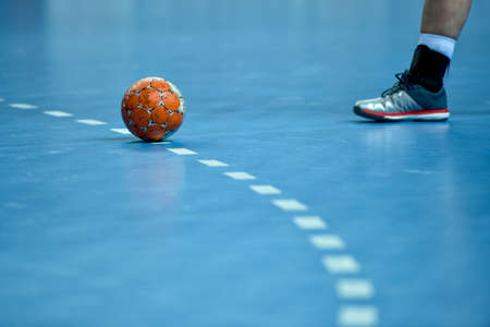 handball ball laying on the 9 meters dotted line on the pitchの写真素材