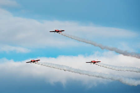 Formation of planes on the blue cloudy sky during the airshow.