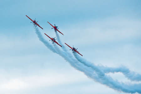 Formation of planes on the blue cloudy sky during the airshow.