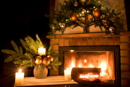 Christmas floral decoration in front of firepace.の写真素材