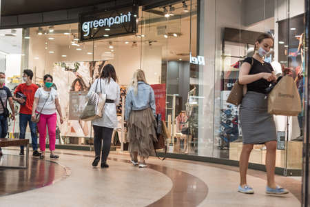 LUBIN, POLAND - APRIL 21, 2020. People in the shopping center with face masks due to coronavirus pandemic.のeditorial素材