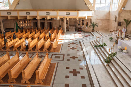 LUBIN, POLAND - MAY 21, 2020. Holy Mass in the Church. Due to the pandemic Covid-19 coronavirus people have face masks and there is social distance.のeditorial素材