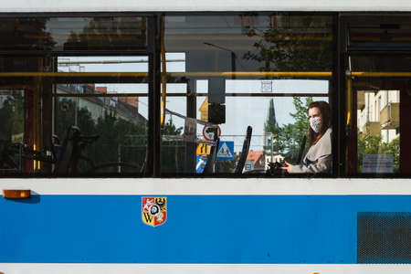WROCLAW, POLAND - MAY 22, 2020. Woman with face mask due to coronavirus pandemic in the tram car.のeditorial素材