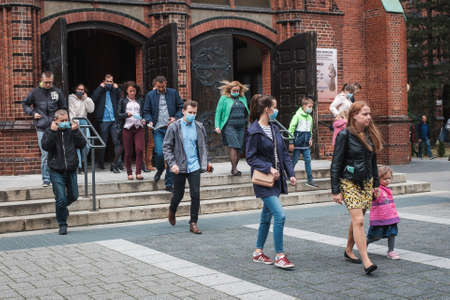 WROCLAW, POLAND - SEPTEMBER 29, 2020. Holy Mass in the Church. People leaving the church. Due to the pandemic Covid-19 coronavirus people have face masks and there is social distance.のeditorial素材