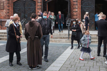 WROCLAW, POLAND - SEPTEMBER 29, 2020. Holy Mass in the Church. Monk collections money from faithful. Due to the pandemic Covid-19 coronavirus people have face masks and there is social distance.のeditorial素材