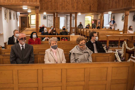 CHOCIANOW, POLAND - OCTOBER 22, 2020. Holy Mass in the Sant Josef Church. Due to the pandemic Covid-19 coronavirus people have face masks and there is social distance.のeditorial素材
