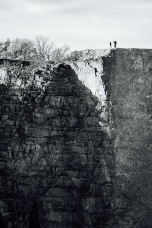 Couple taking picture on the edge of abyss in old quarry Kantyna in Polandの写真素材