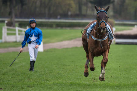WROCLAW, POLAND - APRIL 15; 2018: Race with obstacles for five years and older horses at Racecourse WTWK Partynice. The opening day of the season. In action frightened horse.のeditorial素材
