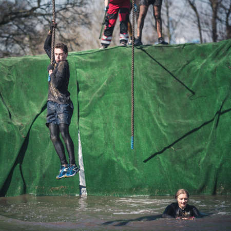 WROCLAW, POLAND - APRIL 7; 2018: Extreme running with obstacle RUNMAGEDDON. In the picture a runner...