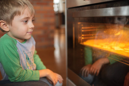 6 years old boy preparing Christmas cake.