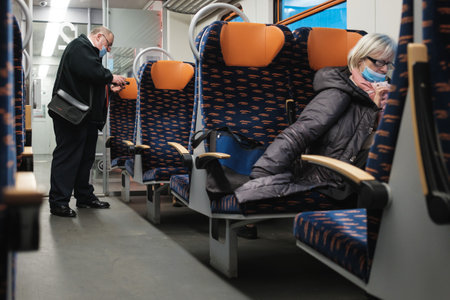 WOLOW, POLAND - JANUARY 9, 2021.guard with face mask due to coronavirus pandemic in the train.