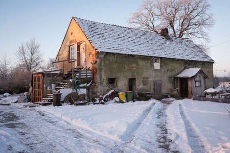 RUSKO, POLAND - FEBRUARY 15, 2021. Detached house in poor condition during a winter morning.のeditorial素材
