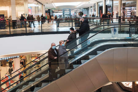 WROCLAW, POLAND - FEBRUARY 1, 2021. People with face masks on the escalator in shopping mall Magnolia.のeditorial素材