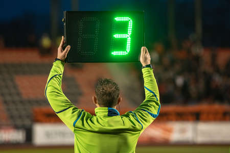 Technical referee shows 3 minutes added time during the football match.