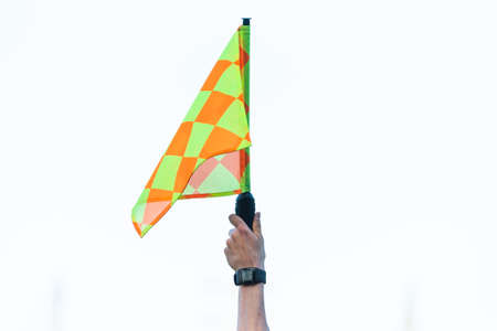 Raised flag by assistant of football referee