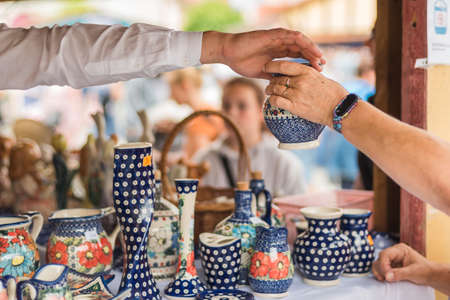 Hands of the seller and the buyer of the ceramic vesselの写真素材