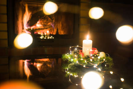 Christmas floral decoration in front of firepace.の写真素材