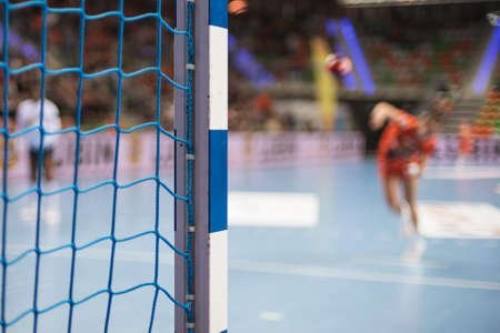 Detail of handball goal post with net and penalty shot in the background.の写真素材