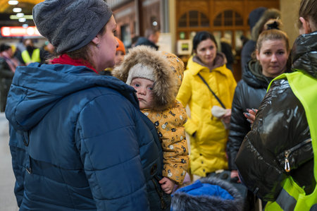 WROCLAW, POLAND - MARCH 11; 2022: Aid for war refugees from Ukraine organized at the railway station in WrocÅaw. Pictured polish volunteers helps refugees.のeditorial素材