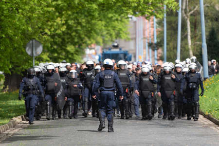 The Police column leads football supporters to the match. The inscription on the uniforms in Polish...