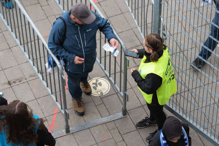 POZNAN, POLAND - MAY 21, 2022: Football match Polish PKO Ekstraklasa between Lech Poznan vs KGHM Zaglebie Lubin 2: 1. Security checks tickets at the entrance to the stadiumのeditorial素材
