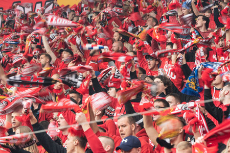 LODZ, POLAND - OCTOBER 16, 2022: Football match Polish PKO Ekstraklasa between Widzew Lodz vs KGHM Zaglebie Lubin 3:0. Cheering supporters of Widzew.のeditorial素材