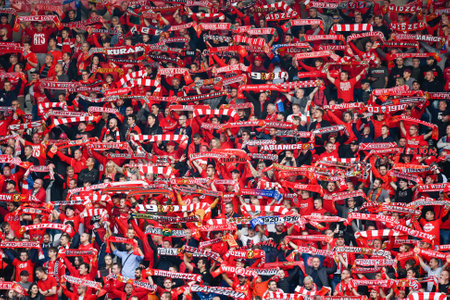 LODZ, POLAND - OCTOBER 16, 2022: Football match Polish PKO Ekstraklasa between Widzew Lodz vs KGHM Zaglebie Lubin 3:0. Cheering supporters of Widzew.のeditorial素材