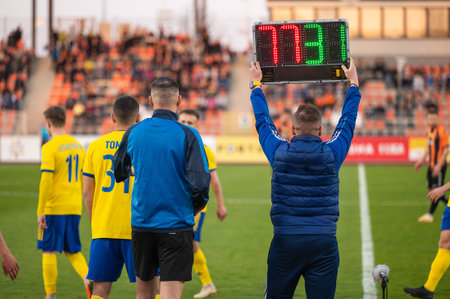 Man shows players substitution during football match.の写真素材