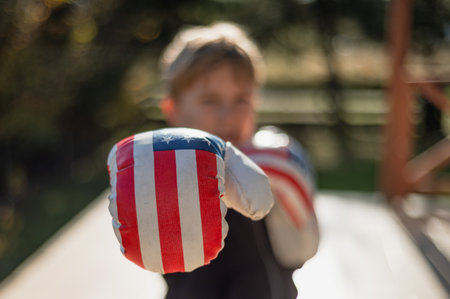 boxing gloves with an American flag on the boy's handsの写真素材