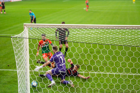 Soccer goal net and action under the goal in the backgroundの写真素材